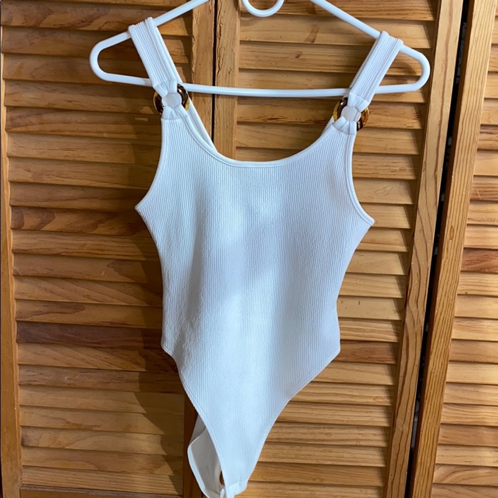 White body suit with circle straps